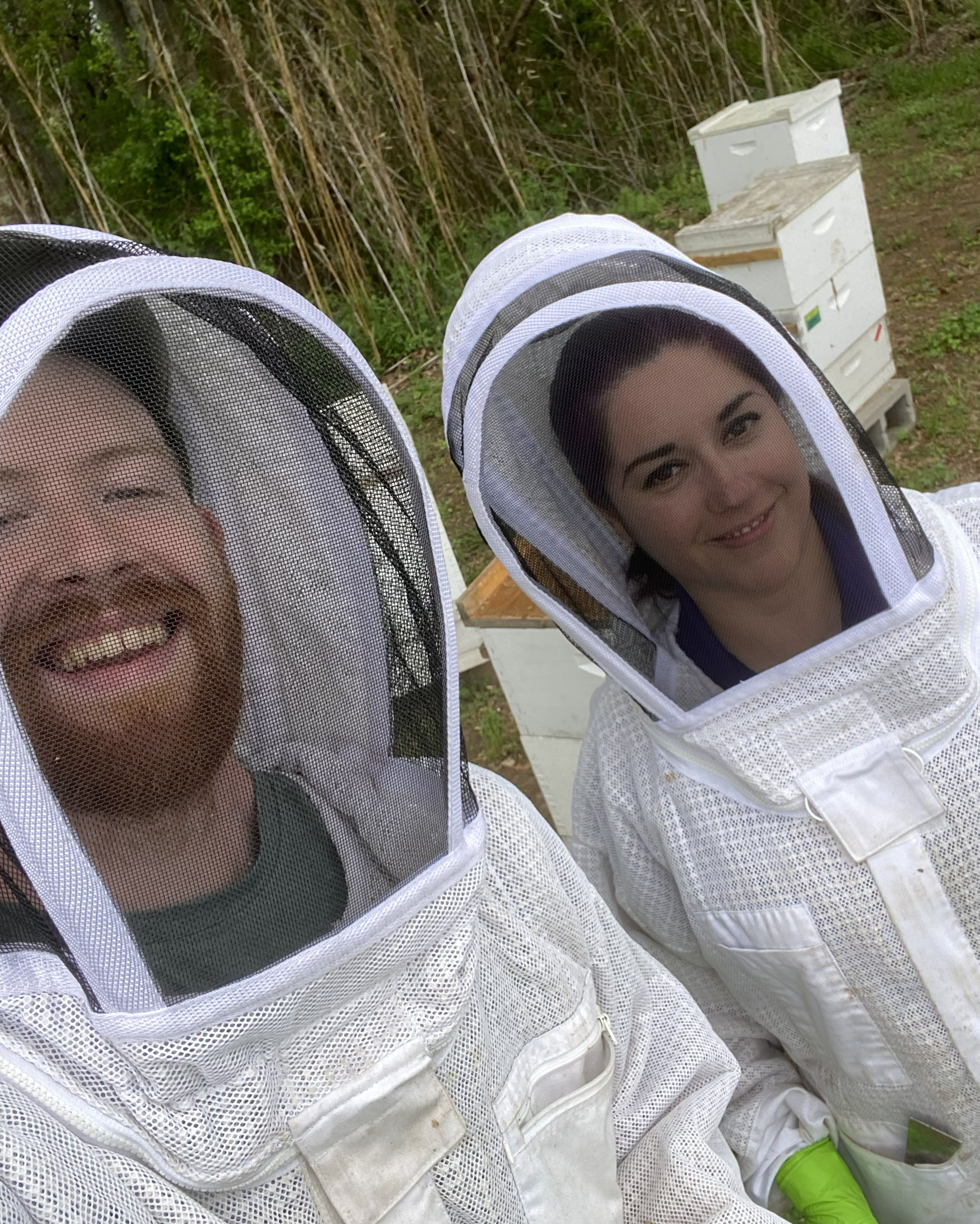 Paula Castillo Bravo and Joseph McCarthy dressed in protective bee gear.