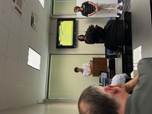 three people giving a presentation at LSU Cybersecurity Clinic