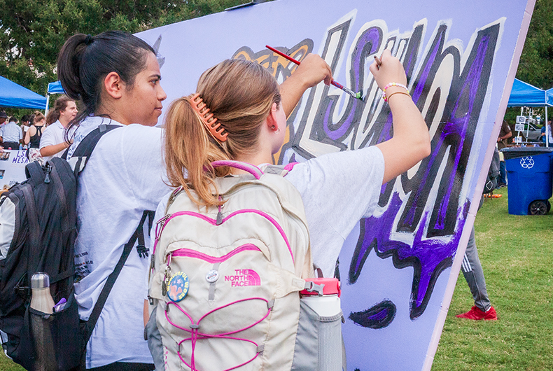 students painting at a table