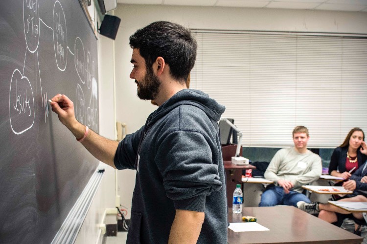 student at chalkboard