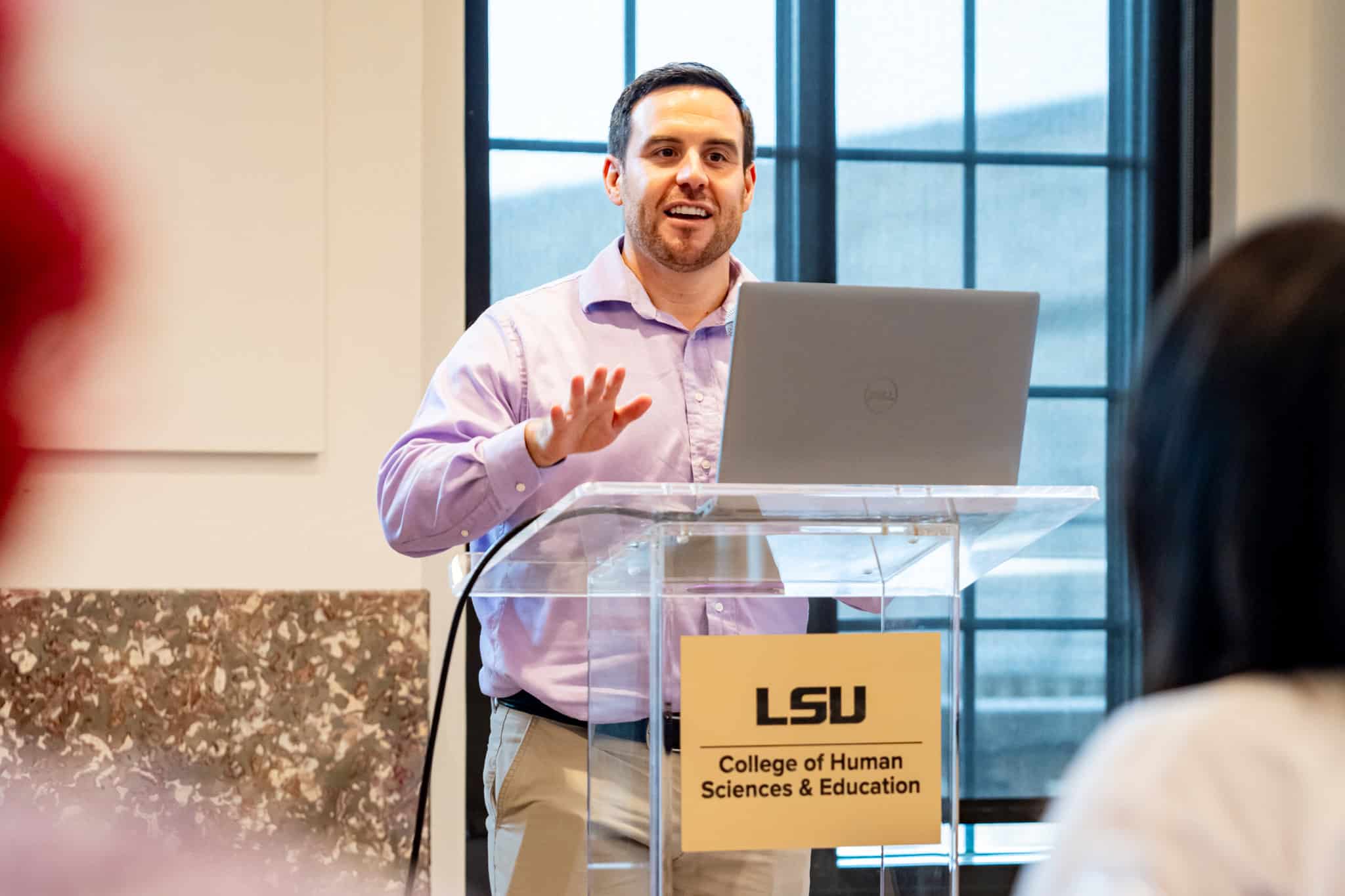 Nicholas Fears presenting at a podium