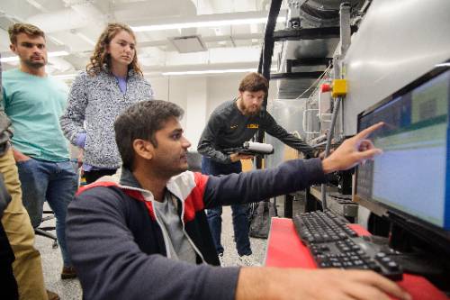 Group looking at a computer screen in lab